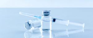 Medical syringe with a needle and a bollte with vaccine